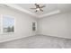 Bedroom featuring neutral walls, gray carpet, tray ceiling, and bright, natural light at 463 Hunton Forest Nw Dr, Concord, NC 28027