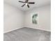 Bedroom features neutral walls, gray carpet, window, and ceiling fan at 463 Hunton Forest Nw Dr, Concord, NC 28027