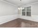 Formal dining room with wainscoting, chandelier, and large window for natural light at 463 Hunton Forest Nw Dr, Concord, NC 28027
