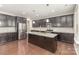 Modern kitchen with dark cabinetry, granite counters, stainless appliances, and a central island at 463 Hunton Forest Nw Dr, Concord, NC 28027