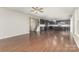 Open-concept living room flows into kitchen, featuring hardwood floors and ample natural light at 463 Hunton Forest Nw Dr, Concord, NC 28027