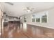 Bright living room connects to kitchen, boasting hardwood floors and sliding door to backyard at 463 Hunton Forest Nw Dr, Concord, NC 28027