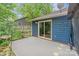 Serene back patio featuring a sliding glass door, decorative sunflower painting, and access to the green backyard at 4810 Shea Ct, Monroe, NC 28110