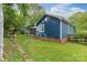 Spacious backyard featuring lush green grass, a charming garden path, and a cozy gazebo, creating a private retreat at 4810 Shea Ct, Monroe, NC 28110