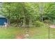 Picturesque backyard featuring a stone pathway, manicured landscaping, and lush greenery, creating a tranquil outdoor space at 4810 Shea Ct, Monroe, NC 28110