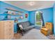 Bedroom showcasing a futon, an accent chair, shelving, and a window at 4810 Shea Ct, Monroe, NC 28110