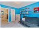 Bedroom with a futon, accent decor, and bright blue walls at 4810 Shea Ct, Monroe, NC 28110