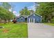 Charming blue single-story home with manicured lawn, and a welcoming driveway leading to the front entrance at 4810 Shea Ct, Monroe, NC 28110