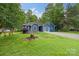 Inviting home featuring a well-manicured lawn, charming landscaping, and a welcoming facade at 4810 Shea Ct, Monroe, NC 28110