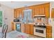 Functional kitchen featuring wood cabinetry, practical appliances, and a cozy corner for dining at 4810 Shea Ct, Monroe, NC 28110