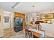 Open-concept kitchen flowing into living room, featuring stainless steel refrigerator and eat in dining area at 4810 Shea Ct, Monroe, NC 28110