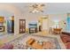 Spacious living room with neutral tones, featuring a large television, decorative furniture, and bright lighting at 4810 Shea Ct, Monroe, NC 28110