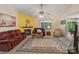 Inviting living room featuring a cozy fireplace, plush seating, and a decorative ceiling fan at 4810 Shea Ct, Monroe, NC 28110