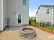 A stone fire pit provides a cozy focal point for this backyard concrete patio at 4912 Grace View Dr, Pineville, NC 28134