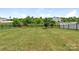 Picturesque backyard with a black metal fence, trees, and lush green grass for outdoor enjoyment at 4912 Grace View Dr, Pineville, NC 28134