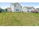 Large backyard with lush green grass, a black metal fence, and a concrete patio for outdoor entertainment at 4912 Grace View Dr, Pineville, NC 28134