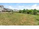 Expansive backyard featuring lush green grass, a black metal fence, and thoughtfully designed garden beds at 4912 Grace View Dr, Pineville, NC 28134