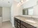 Elegant bathroom featuring dual sinks, granite countertops, and a large mirror at 4912 Grace View Dr, Pineville, NC 28134