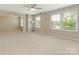 Bright bedroom with plush carpeting and large windows, offering plenty of natural light at 4912 Grace View Dr, Pineville, NC 28134