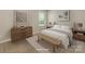Cozy bedroom with neutral tones, warm wood furniture, and natural light from a window at 4912 Grace View Dr, Pineville, NC 28134