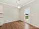Bright breakfast area with hardwood floors and a door leading to the backyard at 4912 Grace View Dr, Pineville, NC 28134