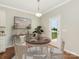 Bright dining area with a round table, stylish rug, and access to the backyard at 4912 Grace View Dr, Pineville, NC 28134