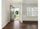 Inviting foyer with dark hardwood floors, fresh paint, and an open view to the front yard at 4912 Grace View Dr, Pineville, NC 28134
