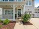 Close-up of a home's front porch with a charming welcome wreath and beautifully landscaped surroundings at 4912 Grace View Dr, Pineville, NC 28134