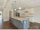 Spacious kitchen features an island, granite countertops, stainless appliances, and white cabinets at 4912 Grace View Dr, Pineville, NC 28134