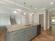 Kitchen features an island with granite counters, gray cabinets, and stainless steel appliances at 4912 Grace View Dr, Pineville, NC 28134