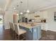 Modern kitchen features granite countertops, stainless appliances, an island with bar seating, and white cabinetry at 4912 Grace View Dr, Pineville, NC 28134