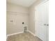 Practical laundry room featuring tile flooring, storage shelves, and hookups for washer and dryer at 4912 Grace View Dr, Pineville, NC 28134