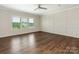 Living room with large windows, ceiling fan, and decorative wall trim at 4912 Grace View Dr, Pineville, NC 28134