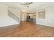 Open concept living room and kitchen with hardwood floors and staircase at 4912 Grace View Dr, Pineville, NC 28134