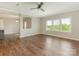 Living room with large windows, hardwood floors, and view into the kitchen at 4912 Grace View Dr, Pineville, NC 28134