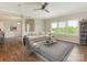 Bright living room features wood floors, neutral walls, and large windows overlooking the landscaped outdoors at 4912 Grace View Dr, Pineville, NC 28134