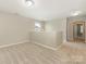 Bright loft area featuring neutral paint, plush carpeting, and a charming chandelier at 4912 Grace View Dr, Pineville, NC 28134