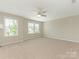 Spacious main bedroom with ample natural light from multiple windows and a modern ceiling fan at 4912 Grace View Dr, Pineville, NC 28134