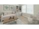 Cozy sitting room with a window, natural light, artwork on the walls, and modern neutral furniture at 4912 Grace View Dr, Pineville, NC 28134