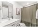 Clean bathroom with white vanity and shower with curtain at 5023 Daybell St, Charlotte, NC 28214