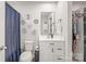 Bathroom with floral decor and a shower with a blue shower curtain at 5023 Daybell St, Charlotte, NC 28214