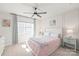 Bedroom with a ceiling fan, neutral walls, and a queen-sized bed at 5023 Daybell St, Charlotte, NC 28214