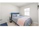 Bedroom with a blue bed, a pink blanket, and a window at 5023 Daybell St, Charlotte, NC 28214