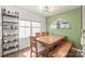 Dining room with an accent wall, open shelving, and natural wood table with bench at 5023 Daybell St, Charlotte, NC 28214