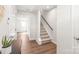 Hallway view showing hardwood floors and carpeted stairs leading to the upper level at 5023 Daybell St, Charlotte, NC 28214