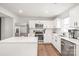 Bright kitchen features an island, stainless steel appliances and white cabinetry at 5023 Daybell St, Charlotte, NC 28214