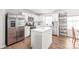 Bright kitchen features an island, stainless steel appliances, white cabinetry and tile backsplash at 5023 Daybell St, Charlotte, NC 28214