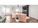 Comfortable living area with a fireplace, TV, and stylish decor with a pastel pink armchair at 5023 Daybell St, Charlotte, NC 28214
