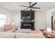Inviting living room with fireplace, tv, and decor with a pastel pink armchair at 5023 Daybell St, Charlotte, NC 28214