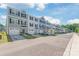 Exterior shot of townhomes with garages and manicured lawns at 5023 Daybell St, Charlotte, NC 28214